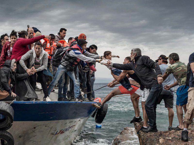 Oct. 11, 2015 - Lesbos Island, Greece - Refugees and Migrants aboard fishing boat driven by smugglers reach the coast of the Greek Island of Lesbos after crossing the Aegean sea from Turkey.